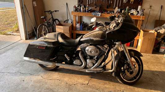Fathers day gift for motorcycle riders, Harley Road Glide bagger parked in suburban garage at golden hour