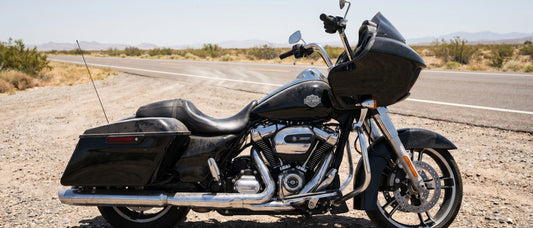 Harley Road Glide parked at a desert roadside pull-off under harsh midday summer sun