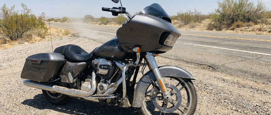 Harley-Davidson Road Glide parked at a sun-baked roadside pull-off on a hot summer day