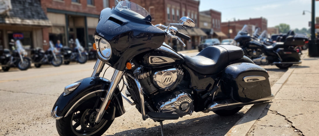 Motorcycle seat cover for sun problem: Indian Chieftain parked on hot Sturgis Main Street under blazing August sky
